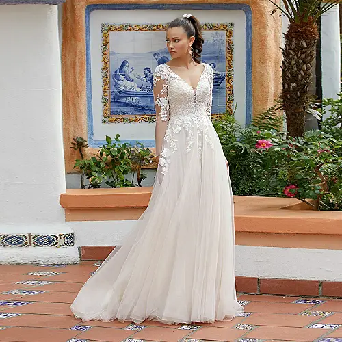 A line wedding dress with lace sleeves in a and romantic style and with a dreamy flowing skirt